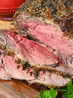 Rib eye roast sliced on a cutting board.
