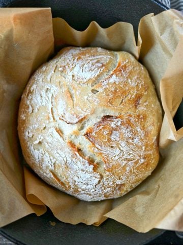 A loaf of artisan bread in a dutch oven.
