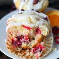 Cranberry orange muffin with a chunk removed from the front.