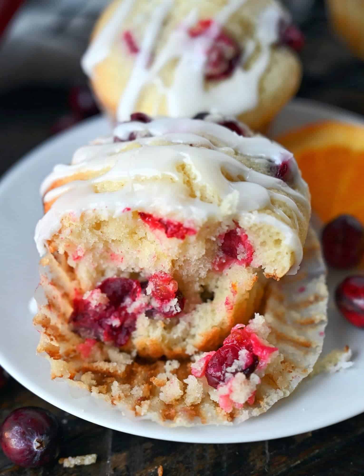 Cranberry orange muffin with a chunk removed from the front.