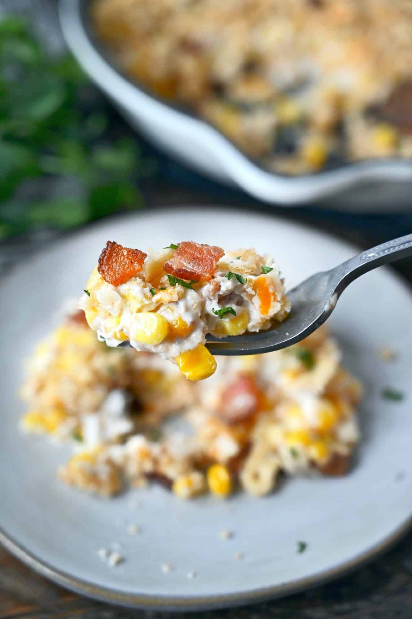 Cheesy creamed corn bite on a fork.