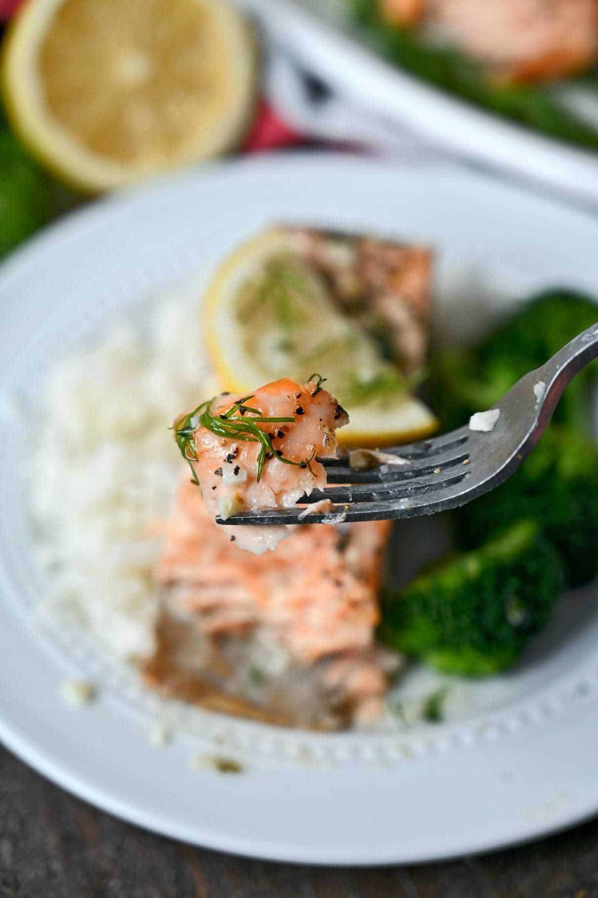 Air fryer lemon butter salmon bite on a fork.