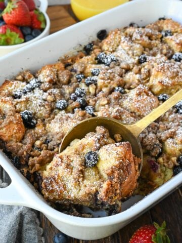 A spoon scooping out some french toast casserole.