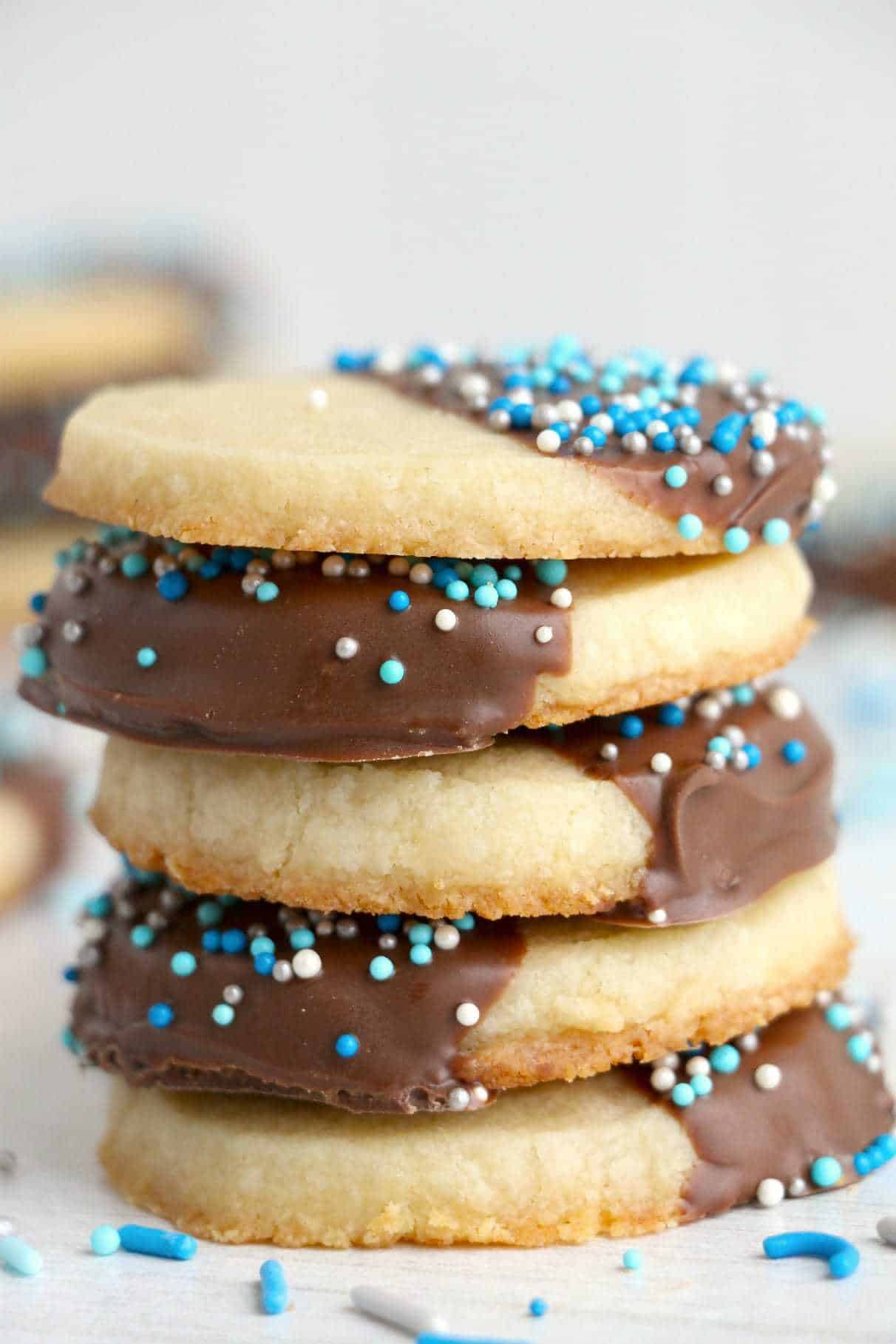 Chocolate dipped butter cookies stacked on top of each other.