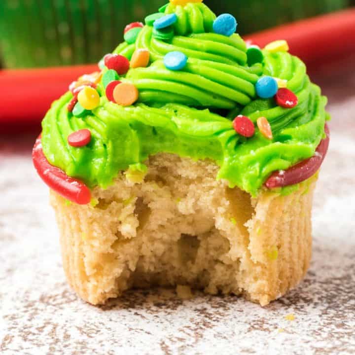 Christmas tree cupcake with a bite out of it.