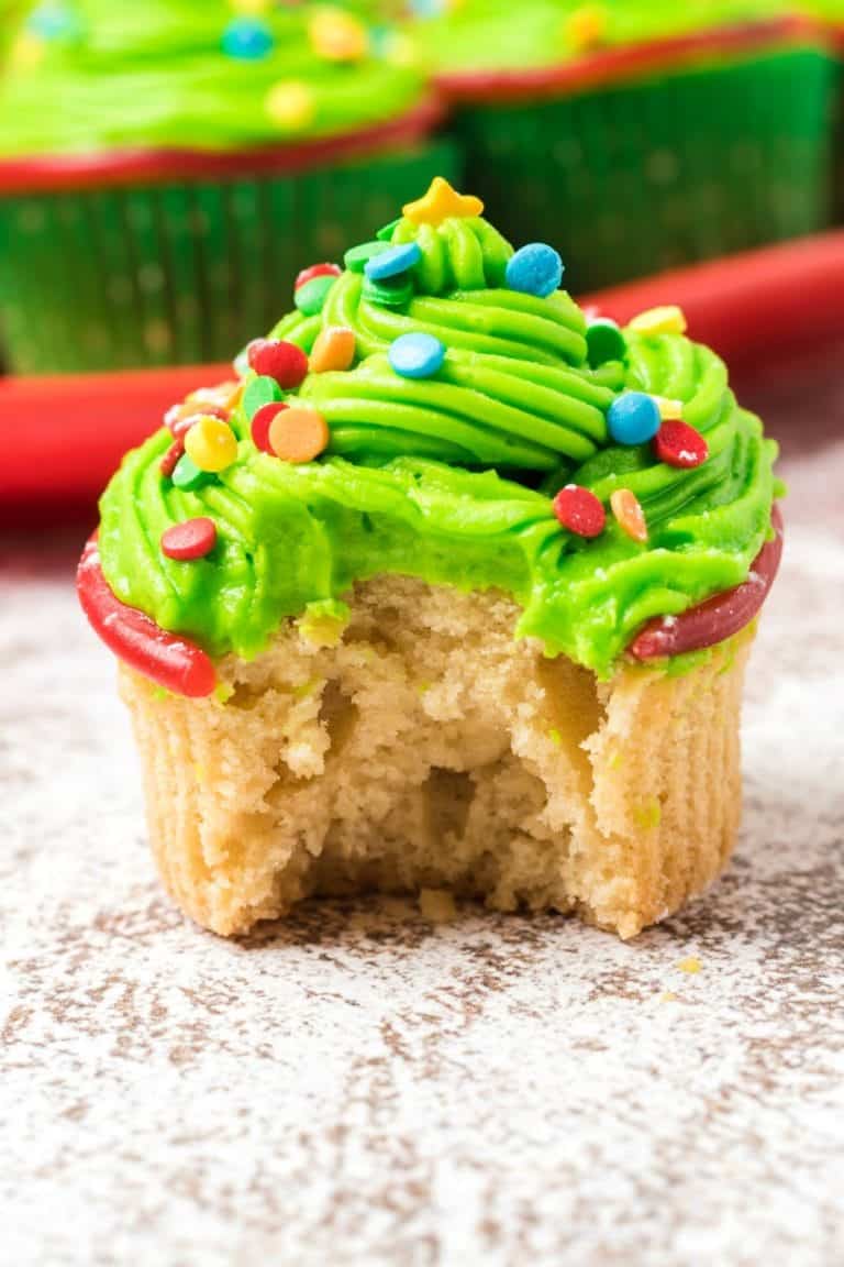 Christmas tree cupcake with a bite out of it.