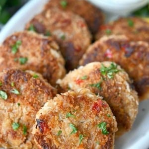 Crab cakes on a white platter.