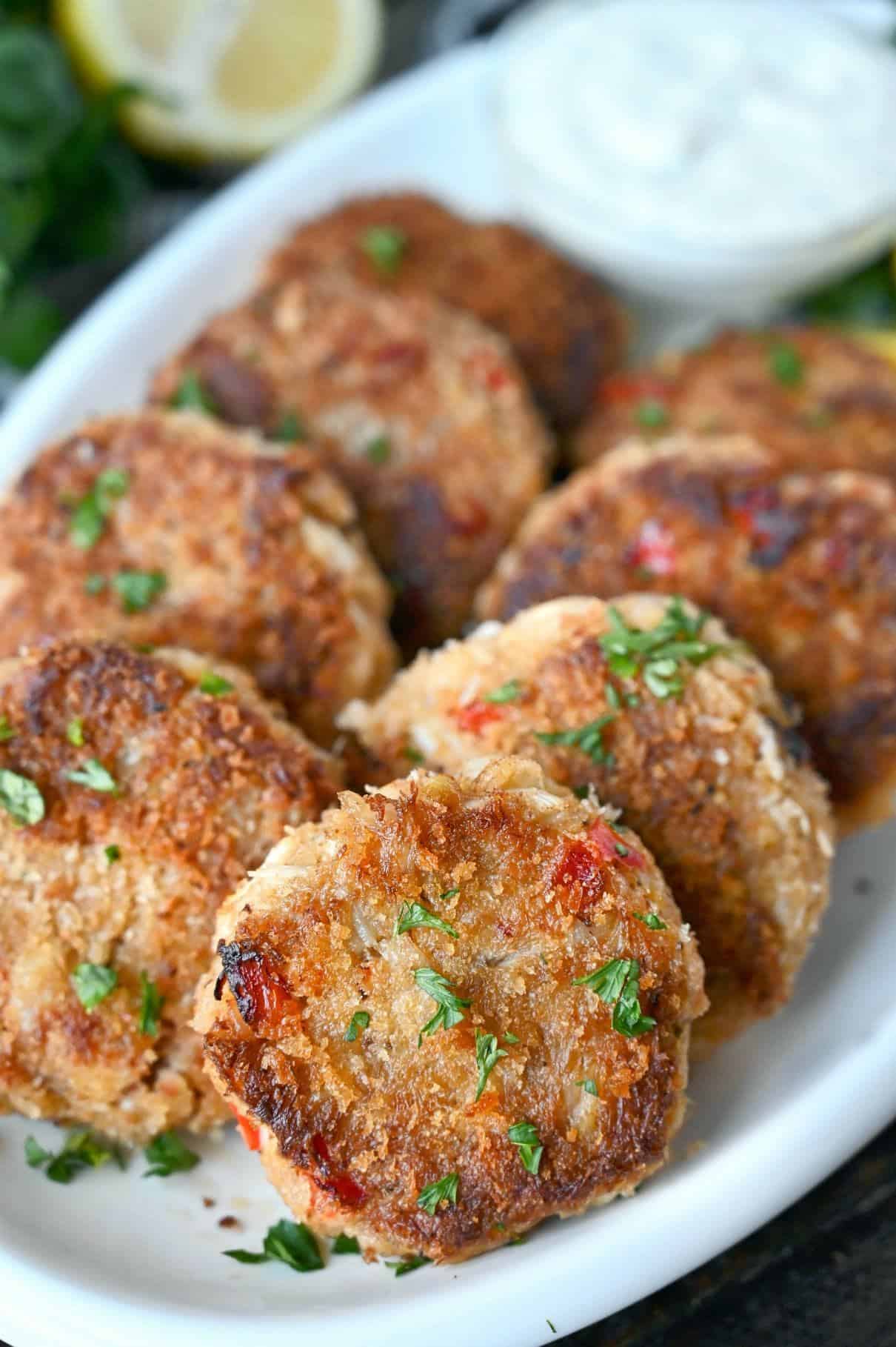 Crab cakes on a white platter.