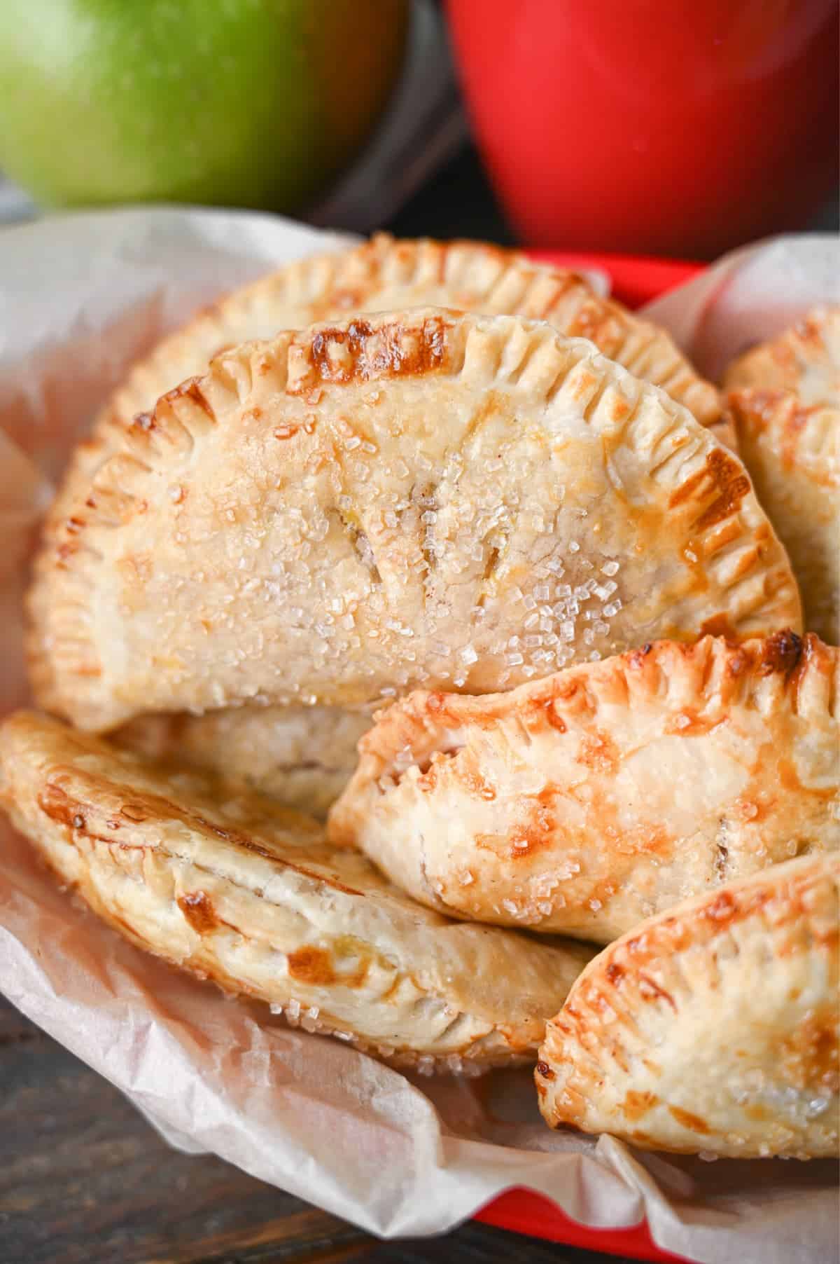 Close up photo of several different hand pies in a red plastic basket.