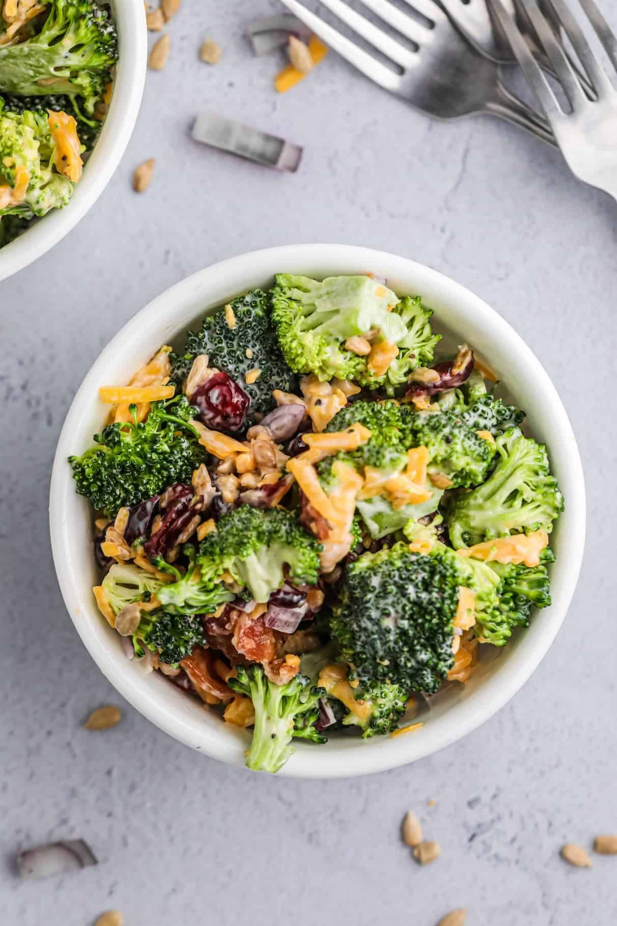 Broccoli salad in a white salad bowl.