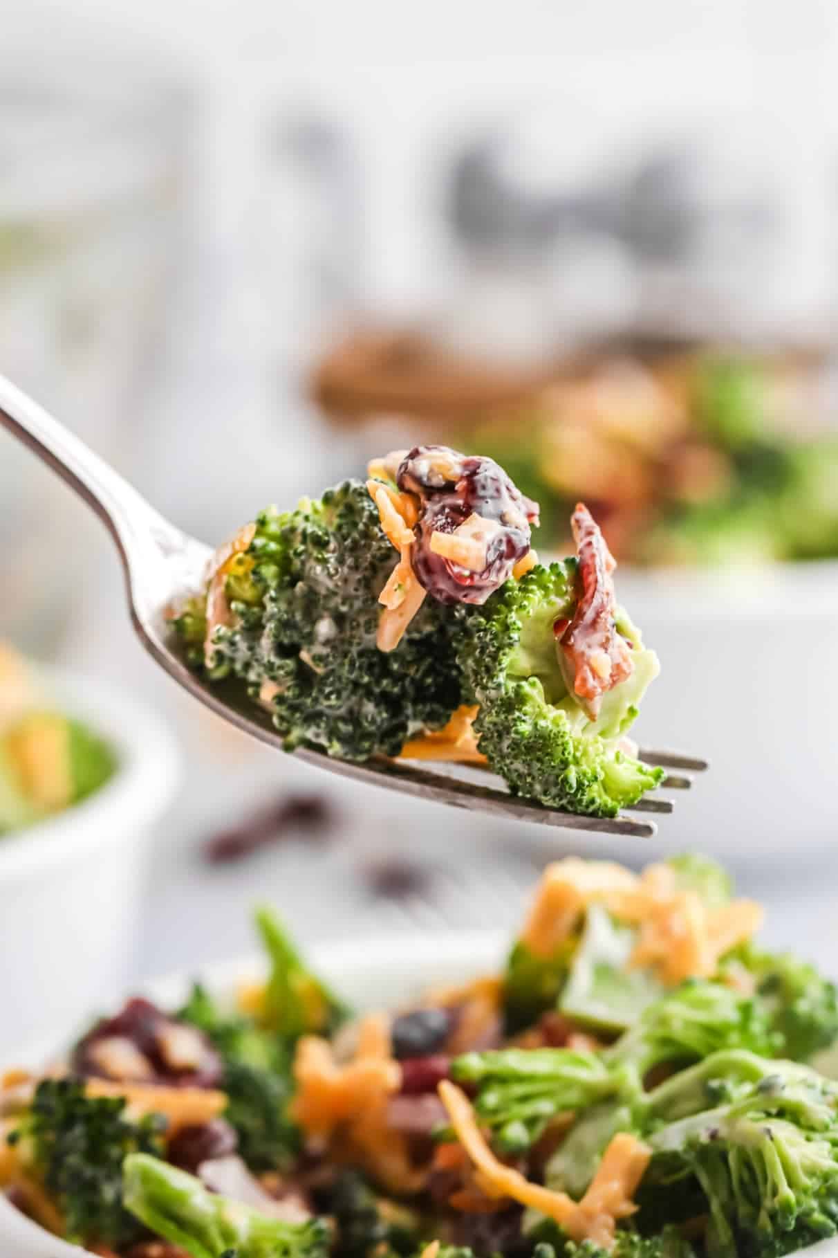 Broccoli salad bite on a fork.