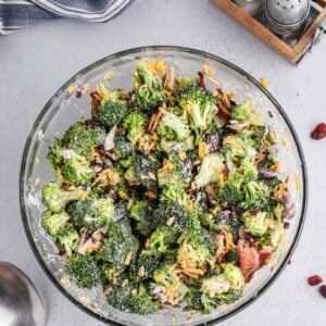 Broccoli salad in a clear glass bowl.