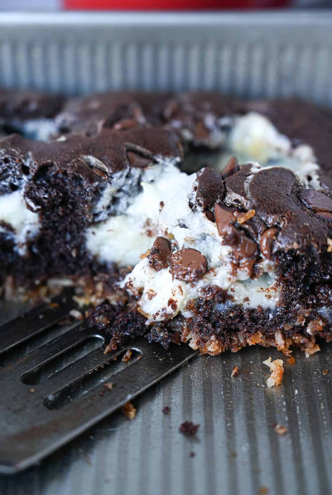 Chocolate earthquake cake in a baking pan with half of it missing.