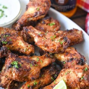 Close up photo of air fryer old bay chicken wings with a side of ranch dressing.