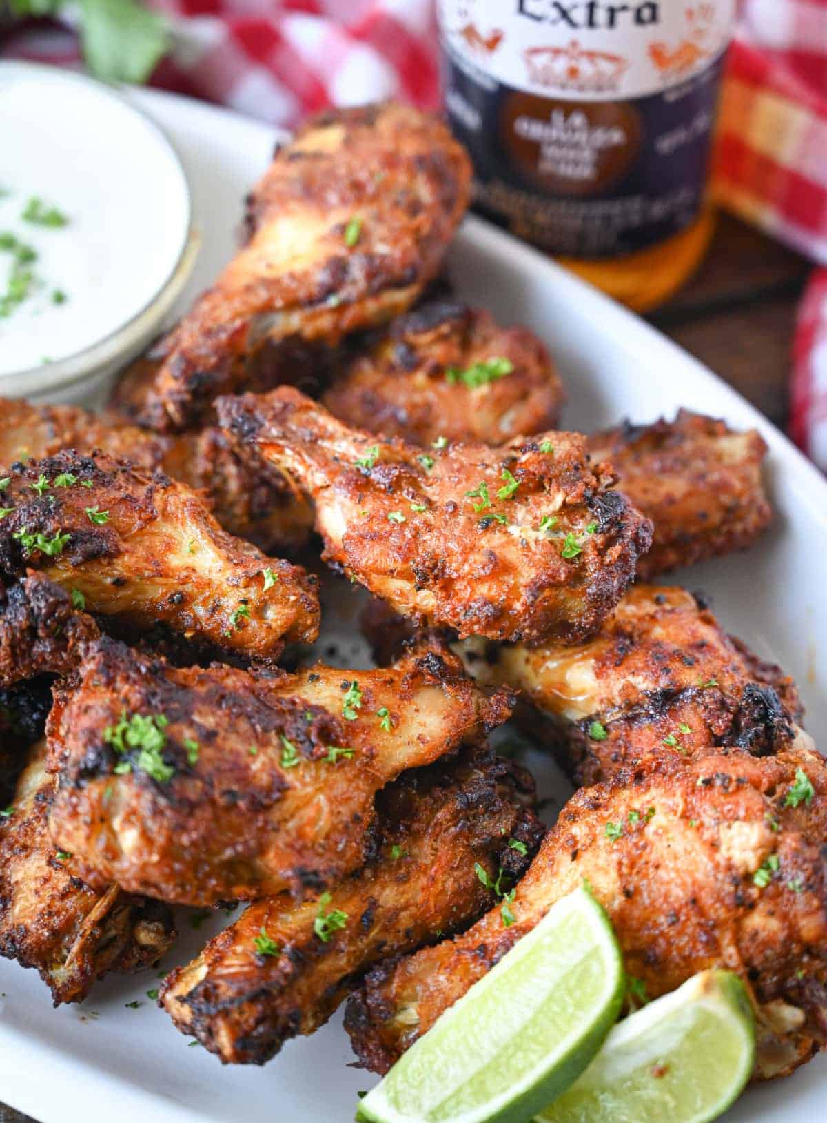 Close up photo of air fryer old bay chicken wings with a side of ranch dressing.