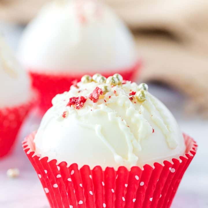 Strawberry hot cocoa bomb in a red cupcake wrapper.