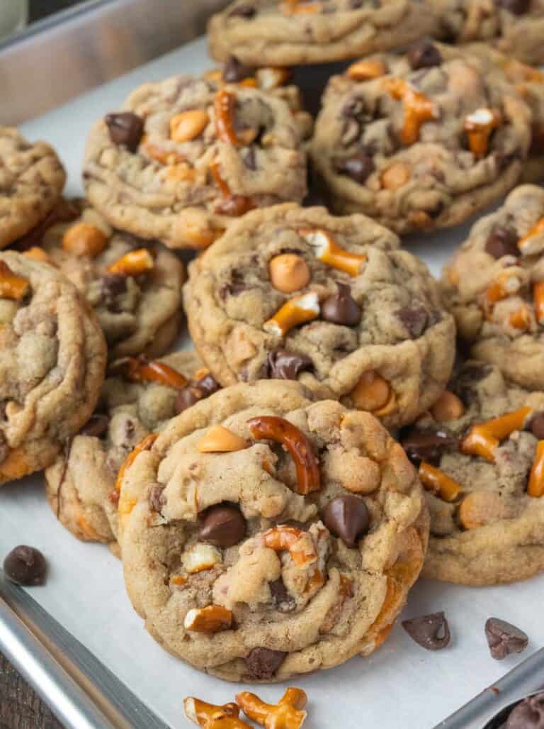Cookies piled on a baking sheet.