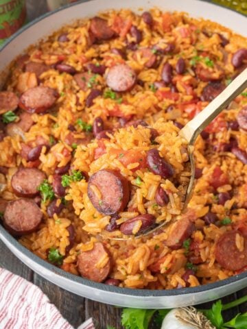 A spoon scooping up some cajun rice and beans.