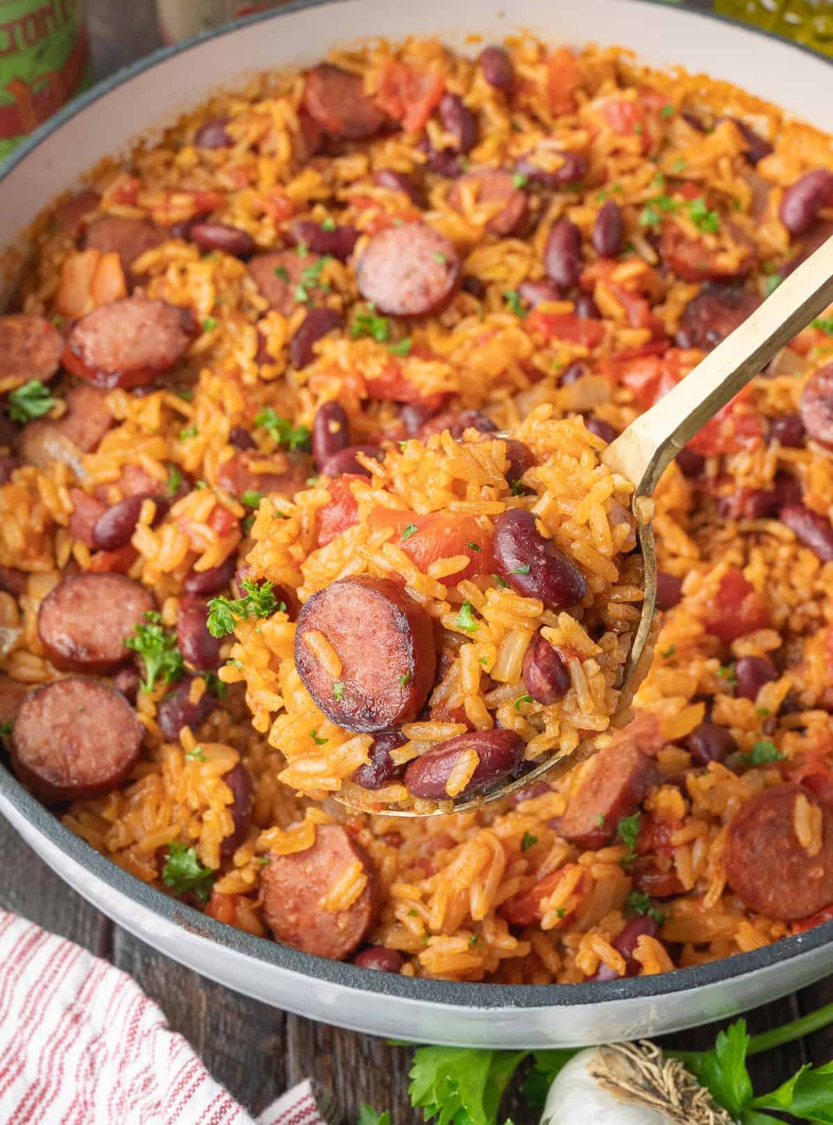 A spoon scooping up some cajun rice and beans.