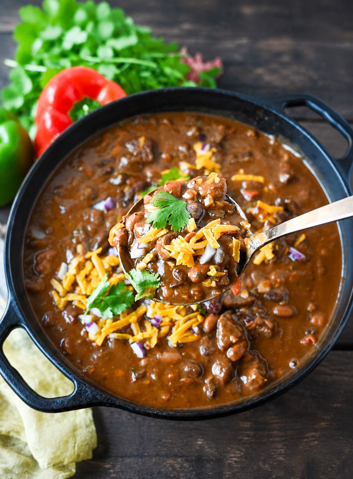 A pot of steak chili with a ladle scooping up a serving.