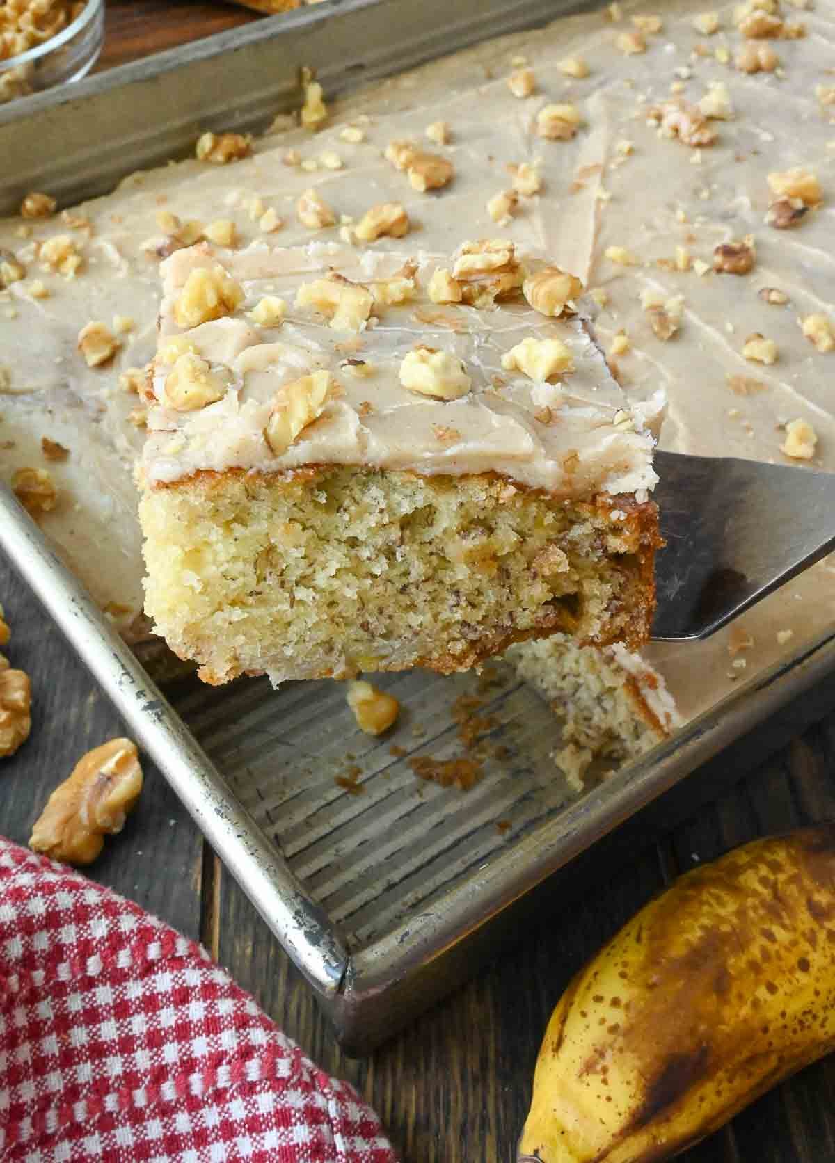 A spatula picking up a slice of banana cake.
