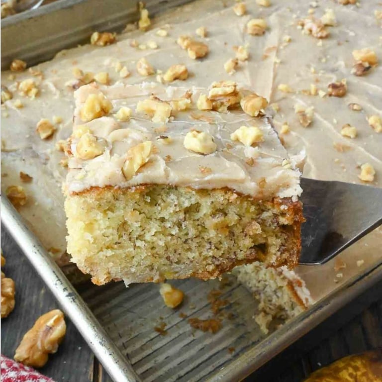 A spatula picking up a slice of banana cake.