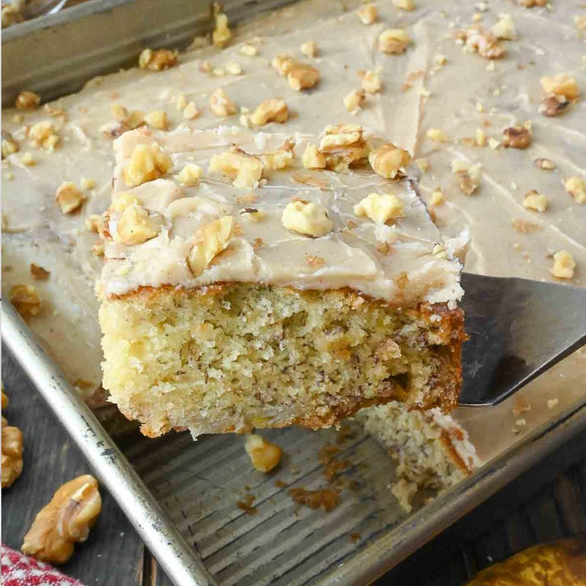 A spatula picking up a slice of banana cake.