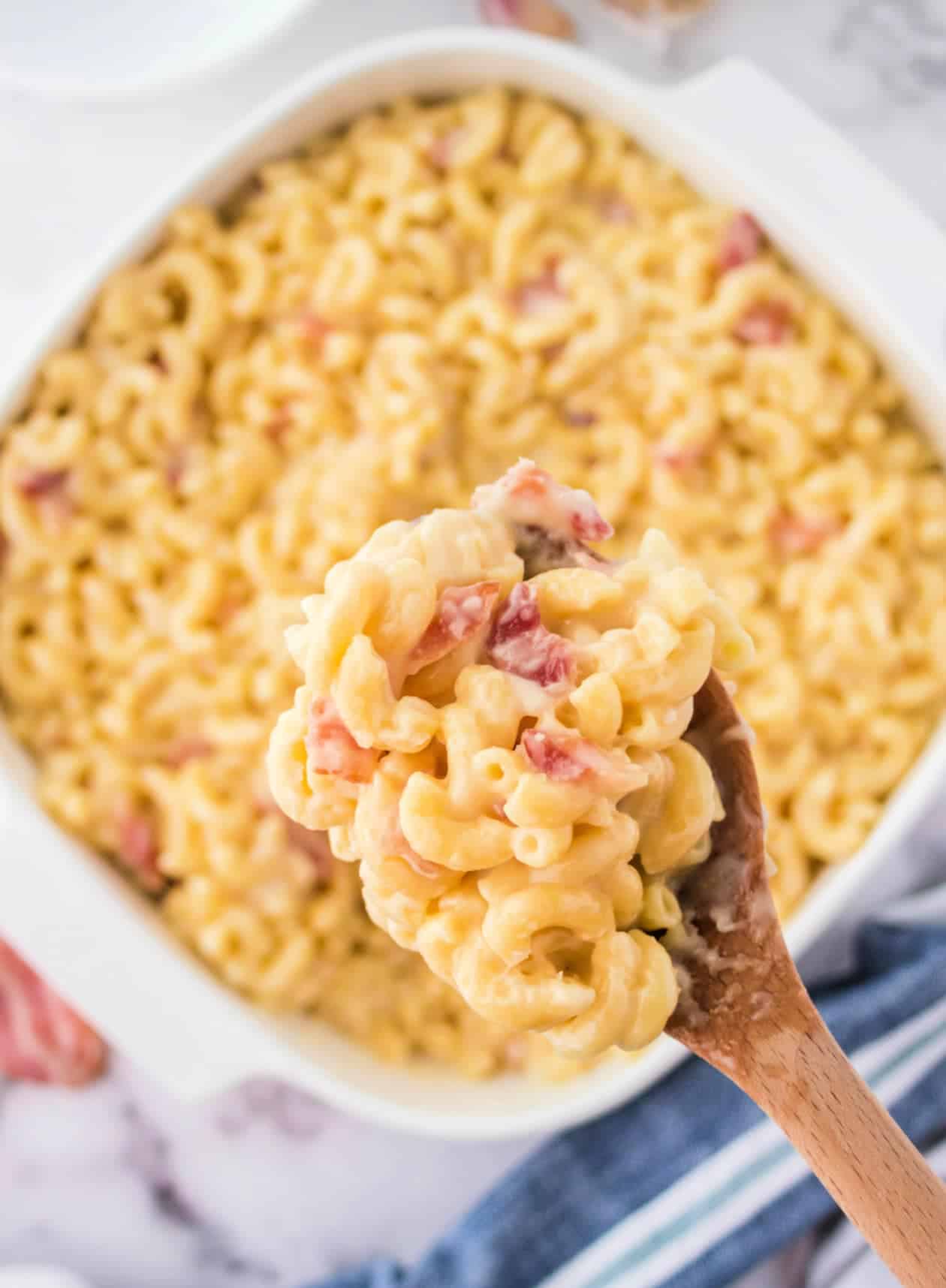 Mac n cheese with bacon in a white square casserole dish.