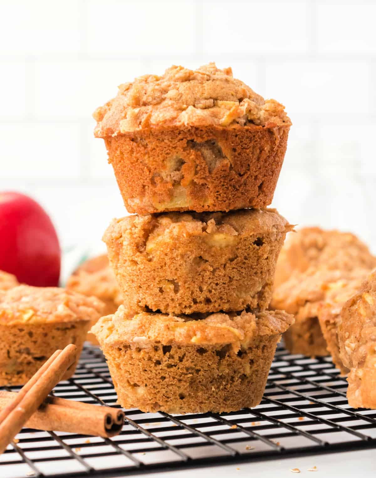 Three apple spice muffins stacked on top of each other.