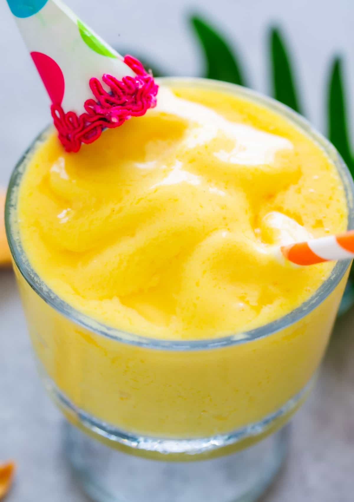 Close up shot of pineapple dole whip in a glass.