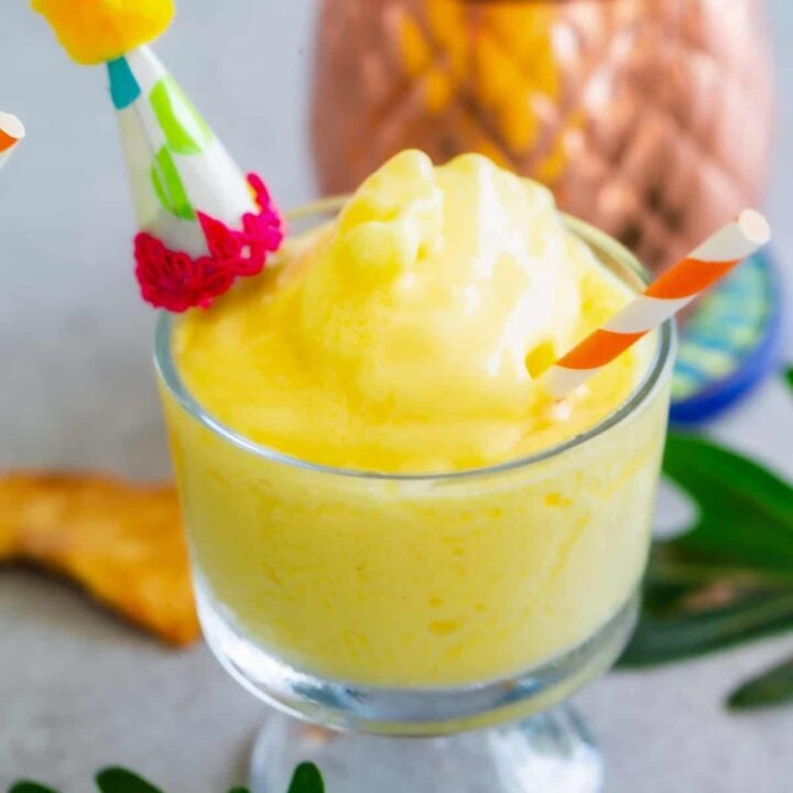 Close up shot of pineapple dole whip in a glass.