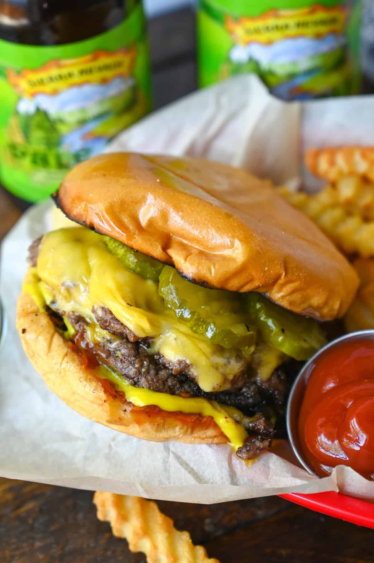 Smash burger with a side of ketchup and fries.