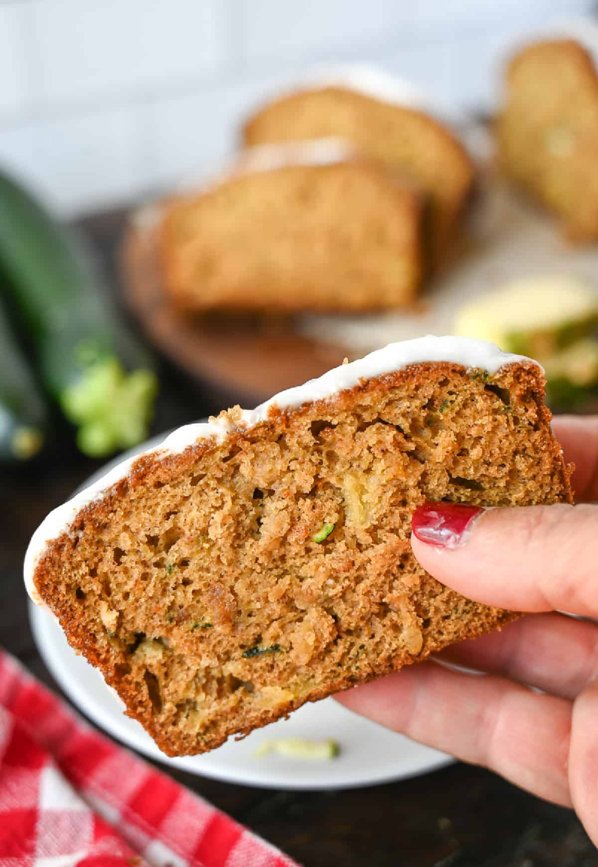 A slice of pineapple zucchini bread being held.