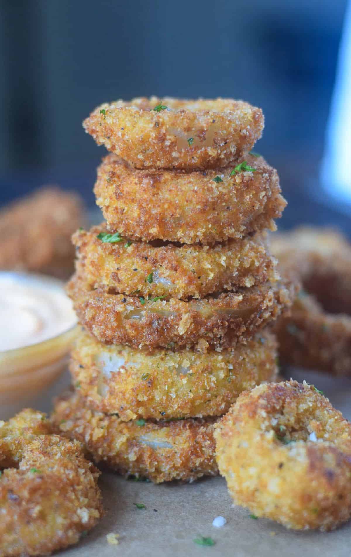 A six high stack of parmesan onion rings.