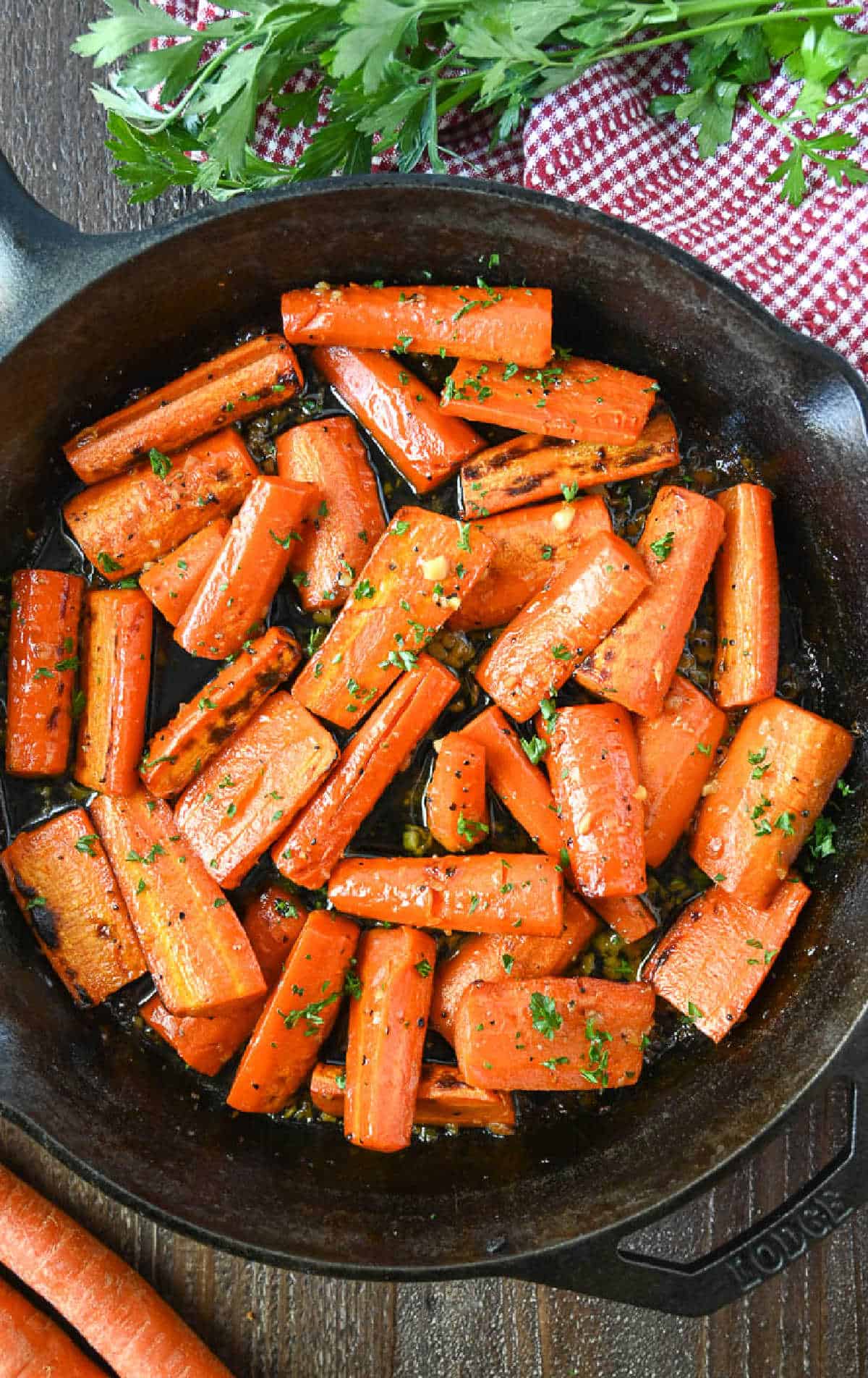 A cast iron skillet with honet roasted carrots.