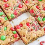 M&M christmas cookie bars cut into squares.
