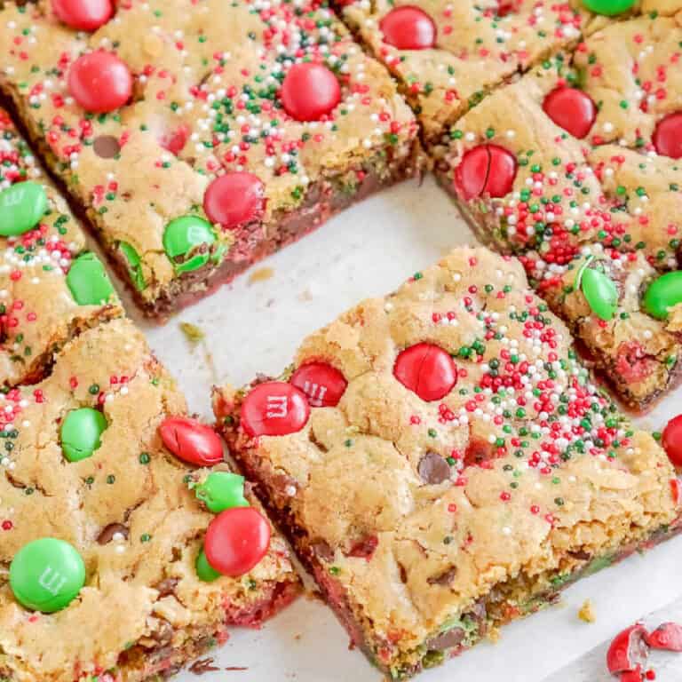M&M christmas cookie bars cut into squares.