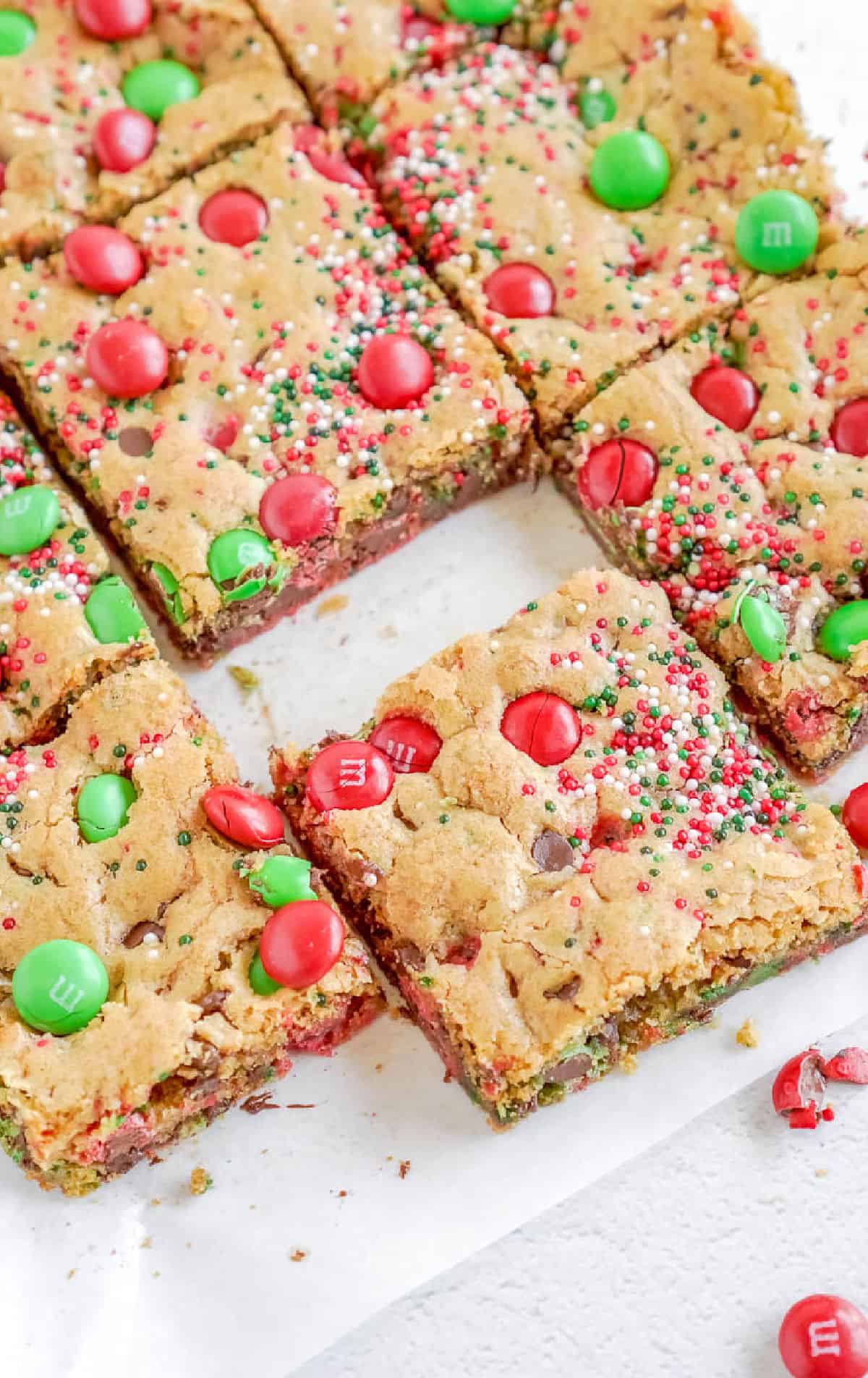 M&M christmas cookie bars cut into squares.