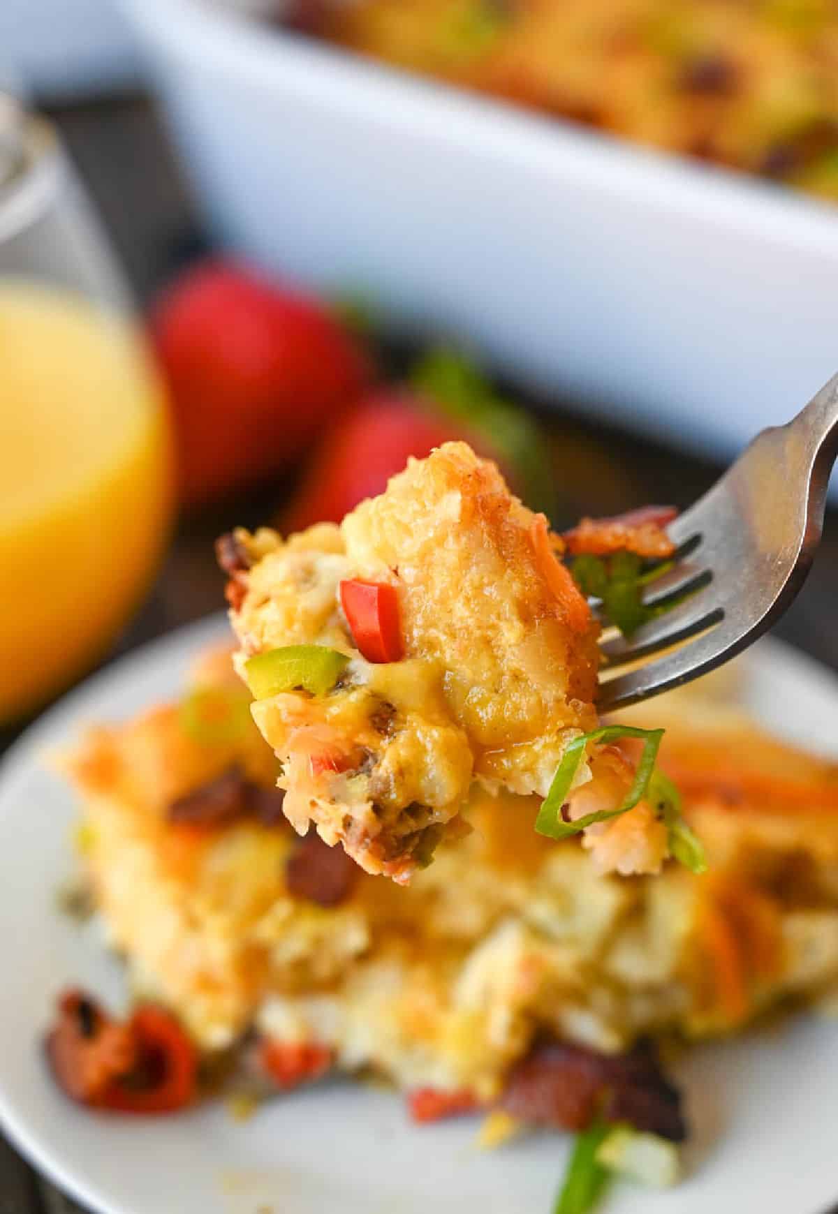 A fork picking up a bite of tator tot casserole.