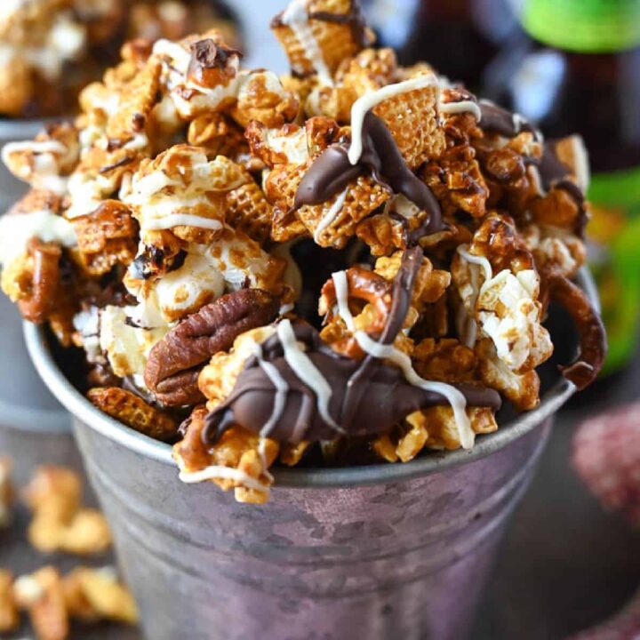 A metal bucket full of crunchy caramel snack mix.