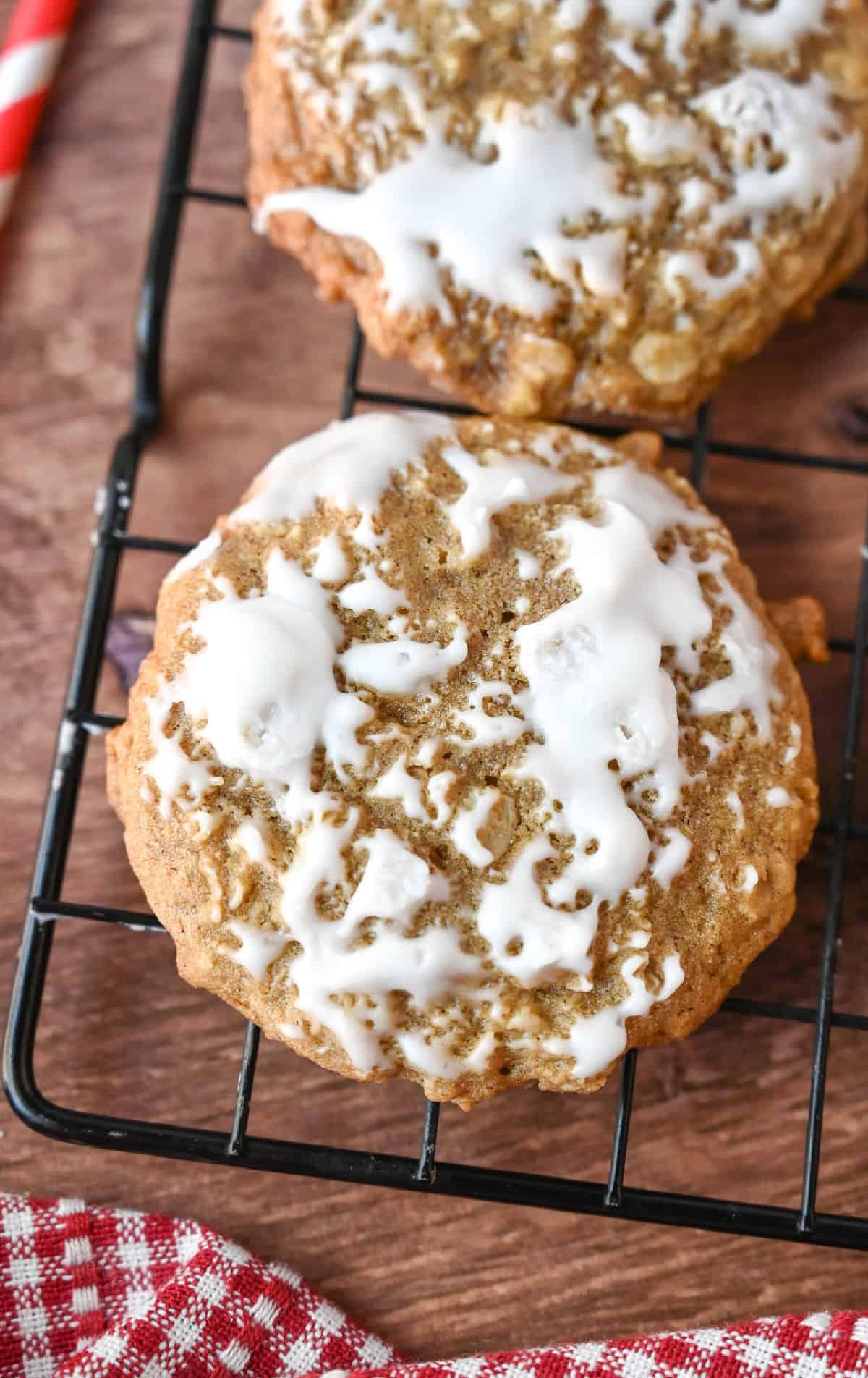 Iced oatmeal cookies on a cooling rack.