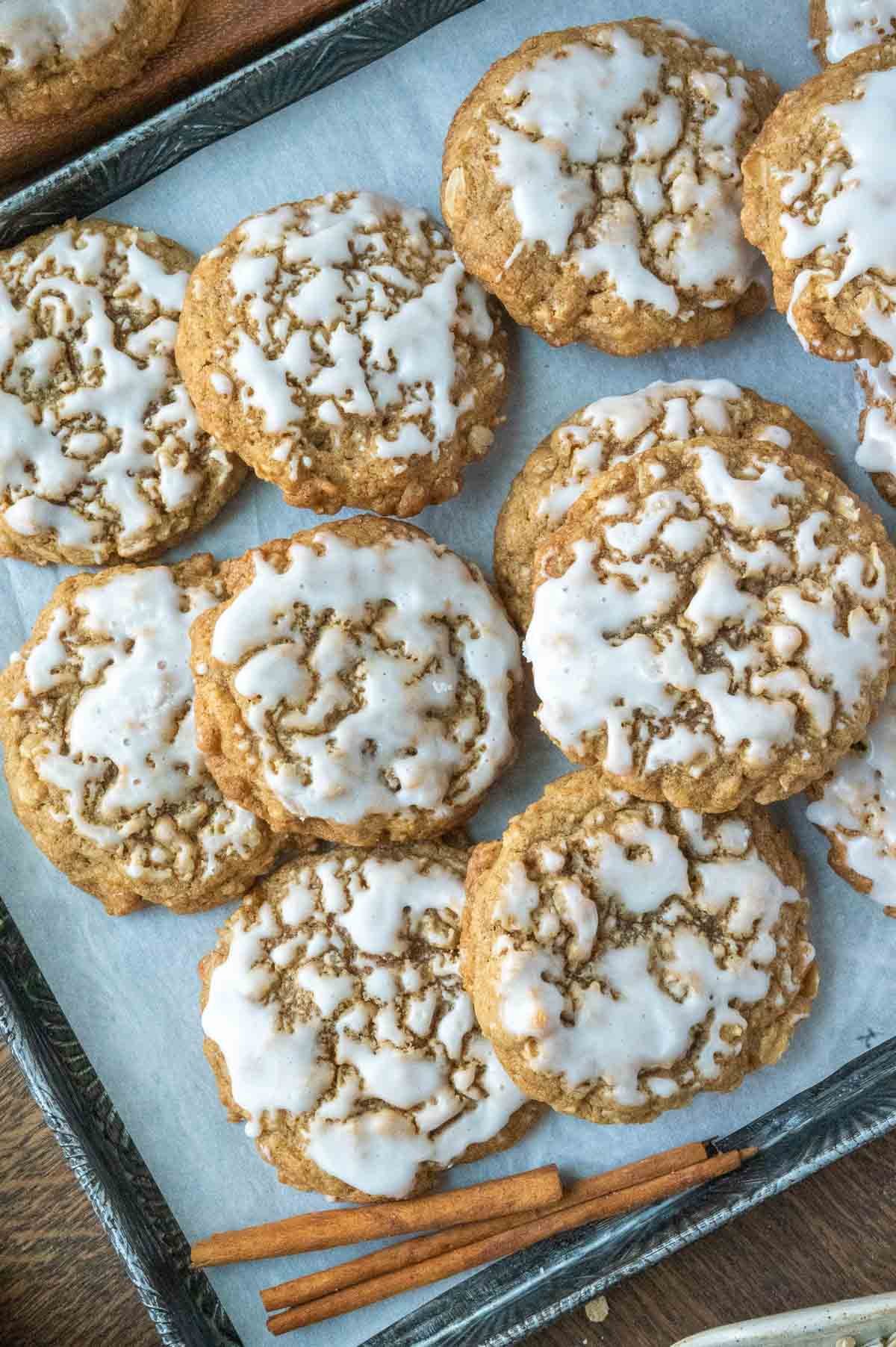 Iced Oatmeal cookies on a baking sheet.
