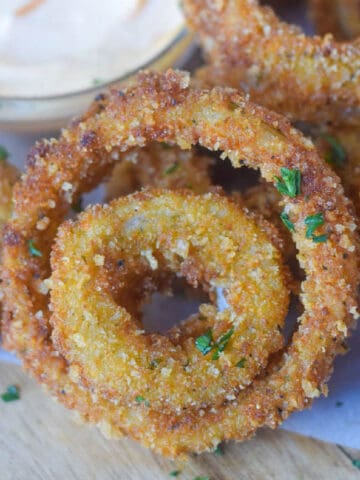 A close up photo of a few onion rings.
