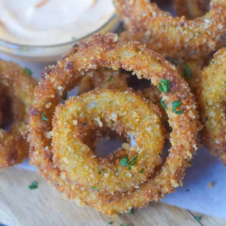 A close up photo of a few onion rings.