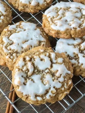 Iced oatmeal cookies on a cooling rack.