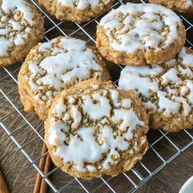 Iced oatmeal cookies on a cooling rack.