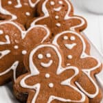 A close up photo of several gingerbread cookies on a white plate.