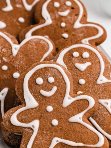 A close up photo of several gingerbread cookies on a white plate.