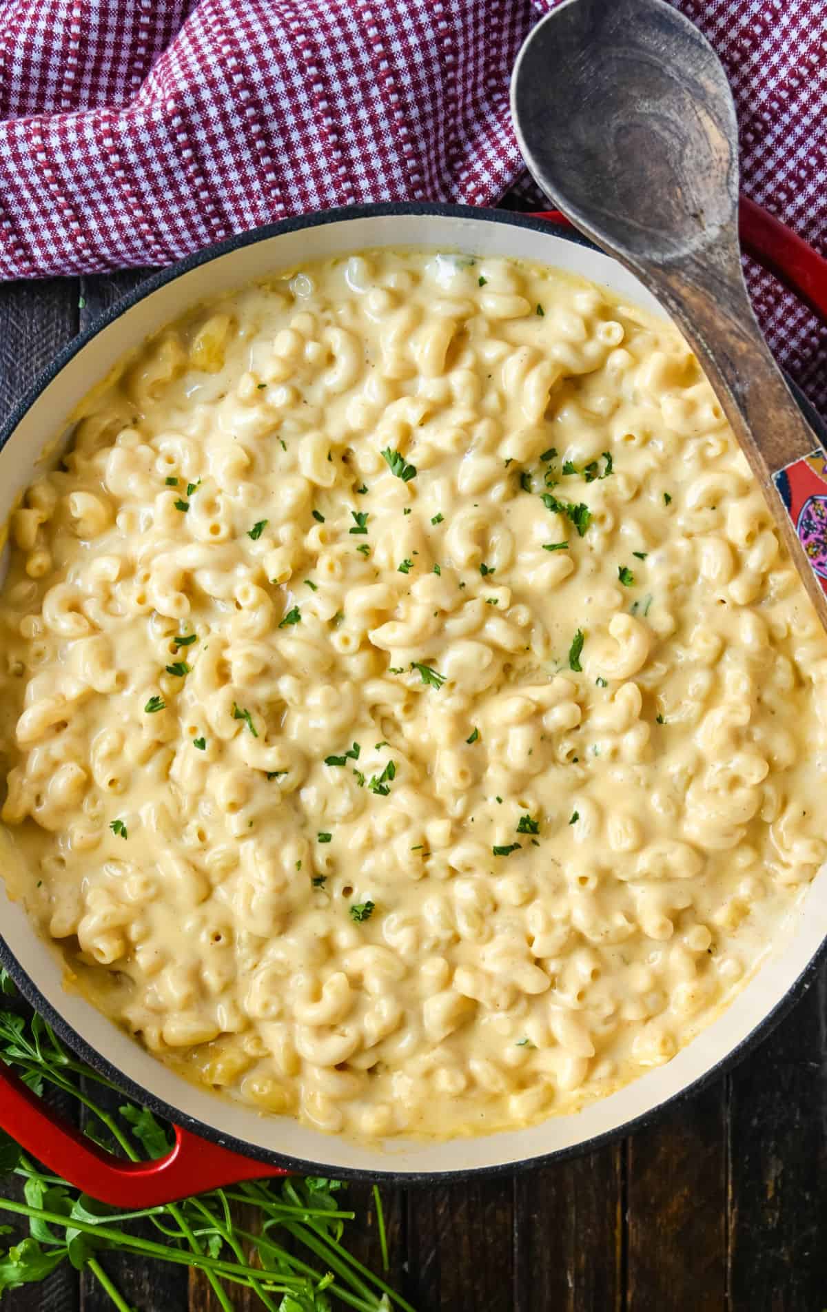 Stovetop macaroni and cheese in a red cast iron skillet.