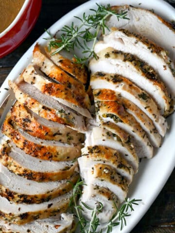 A close up photo of sliced turkey in a white plate.